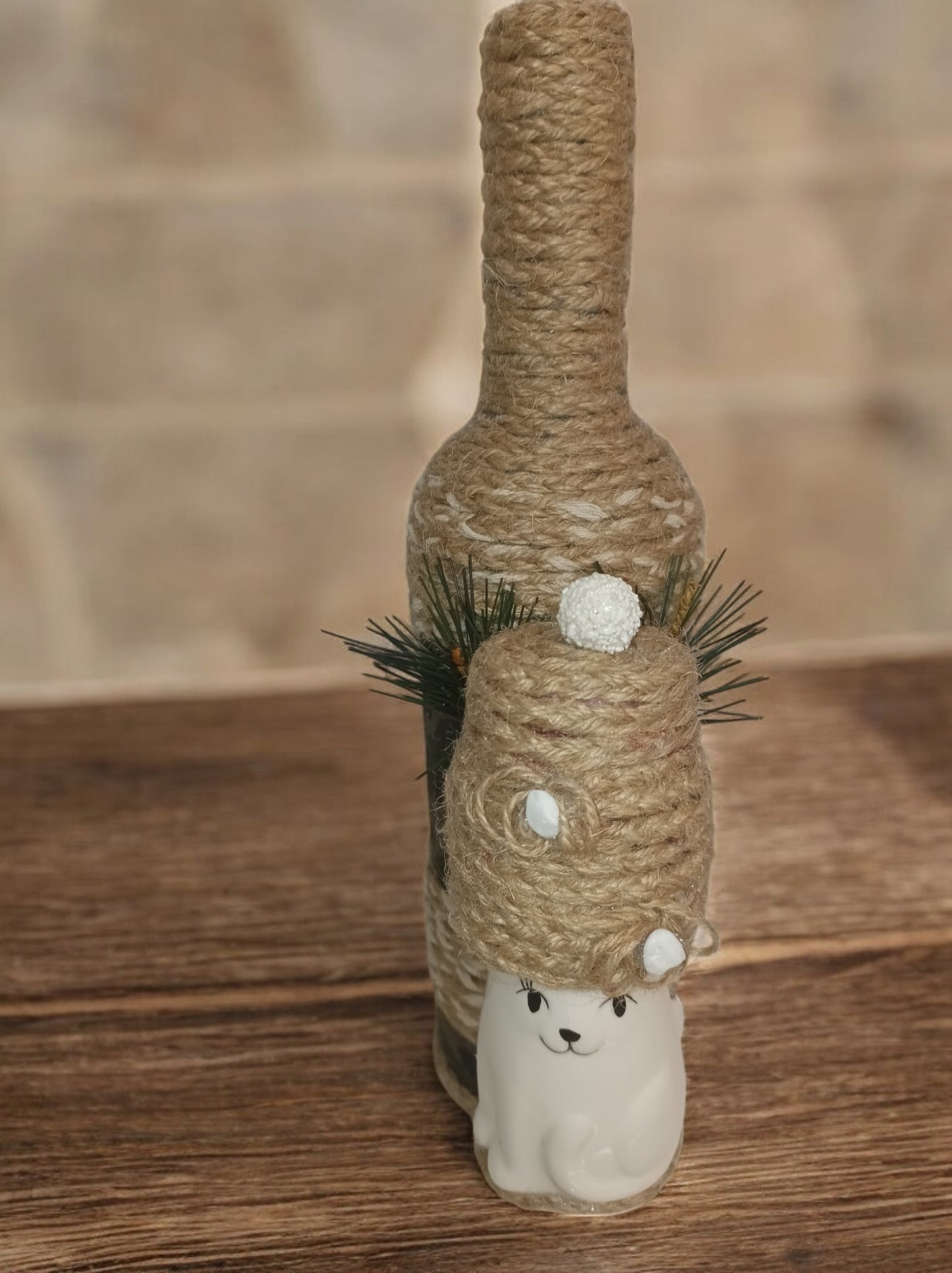 Dressed up bottle with a cat ornament
