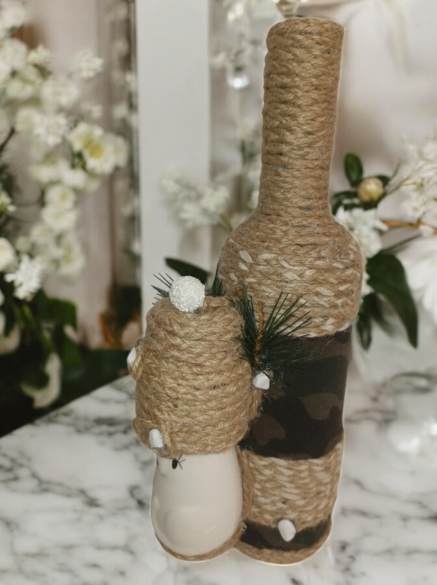 Dressed up bottle with a cat ornament